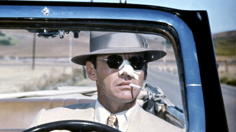 Jake Gittes smokes a cigarette as he drives through the San Fernando Valley's sparse farmland.