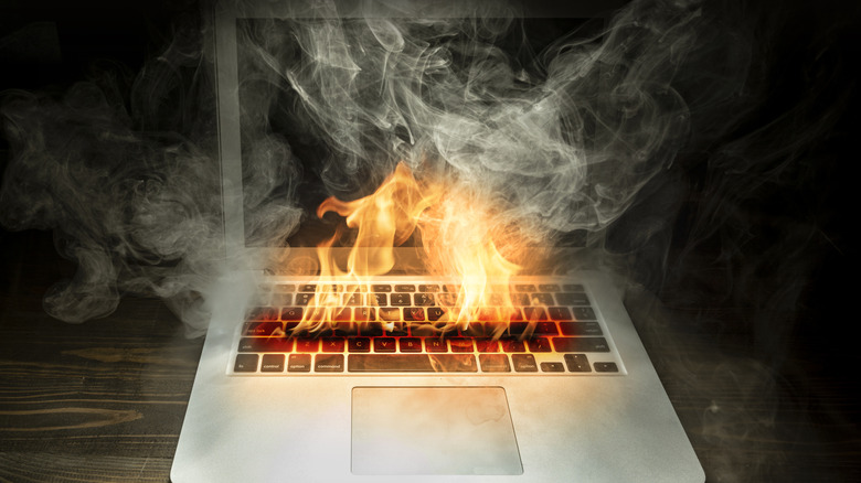 a laptop that is on fire from overheating