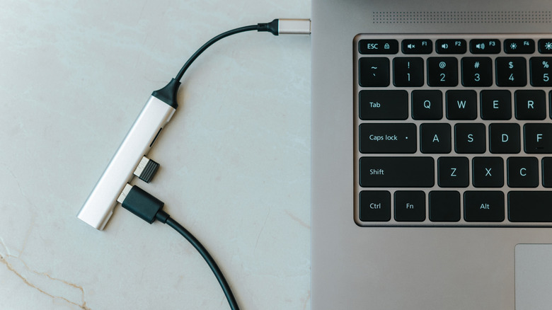 A small USB hub plugged into a laptop.