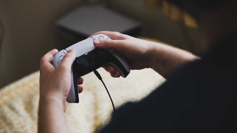 A headphone jack connected to a PS5 controller