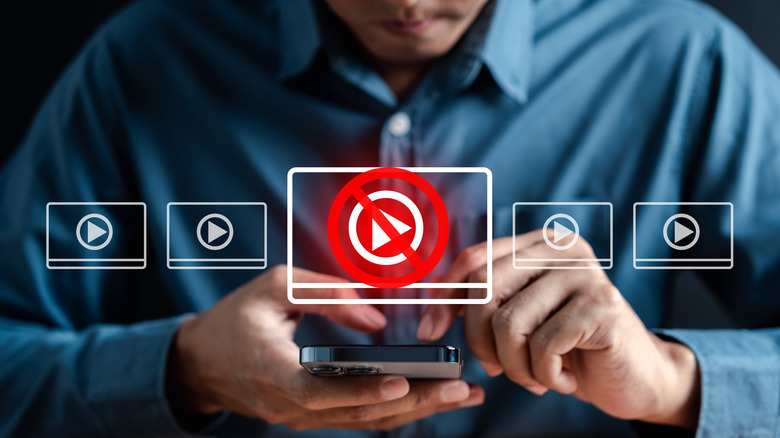 concept for adblocker hovering over a phone being held by a man in a nice shirt