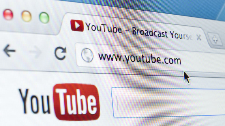 Close-up of a monitor showing the YouTube home page on a browser