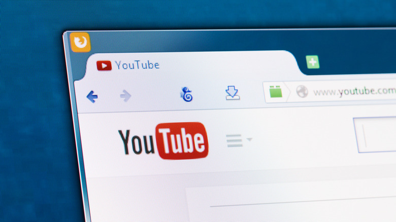 The YouTube logo in a browser window on a monitor.