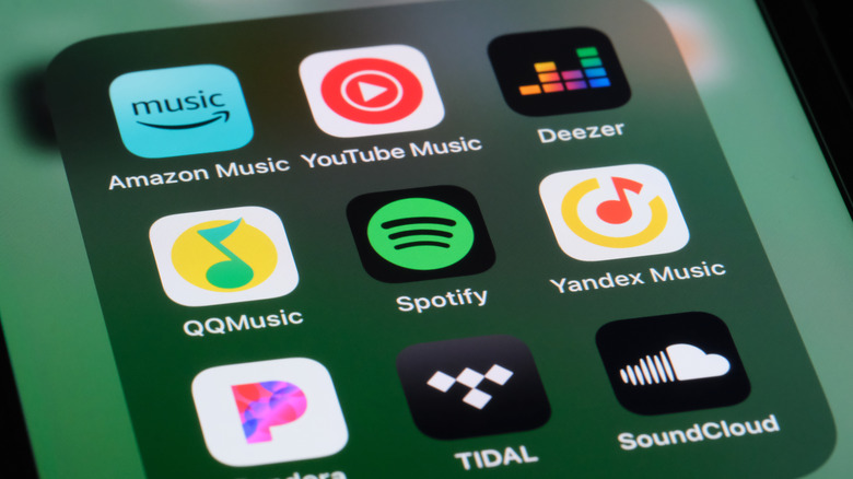 Music services icons visible on a smartphone display.