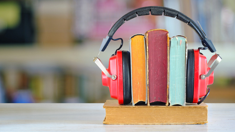 audiobook concept, headphones on three books showing their pages and spines