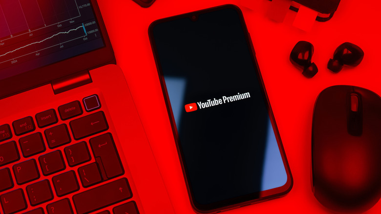 Smartphone on surface showing Youtube Premium logo.