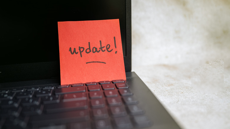 update written on a red piece of paper placed on a laptop