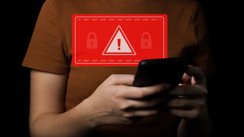 Personal holding phone with data breach warning