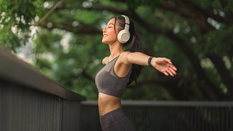 Woman wearing headphones outside during exercise.