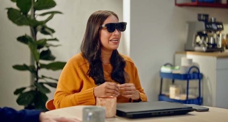 A person using Project Aura glasses in a coffee shop.